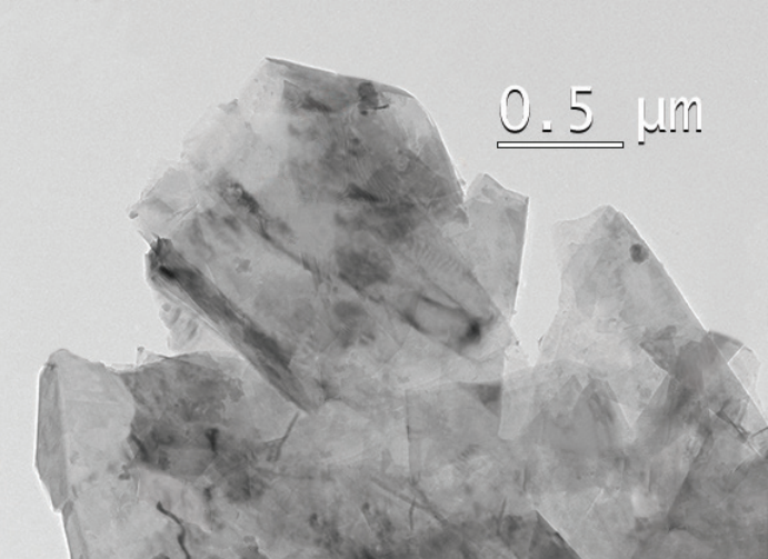 Transmission electron micrograph of industrial grade graphene nanoplatelets showing several stacked few-layer thick flakes with irregular edges against a 0.5 micron scale bar, illustrating the 6 to 10 layer thickness range of this grade